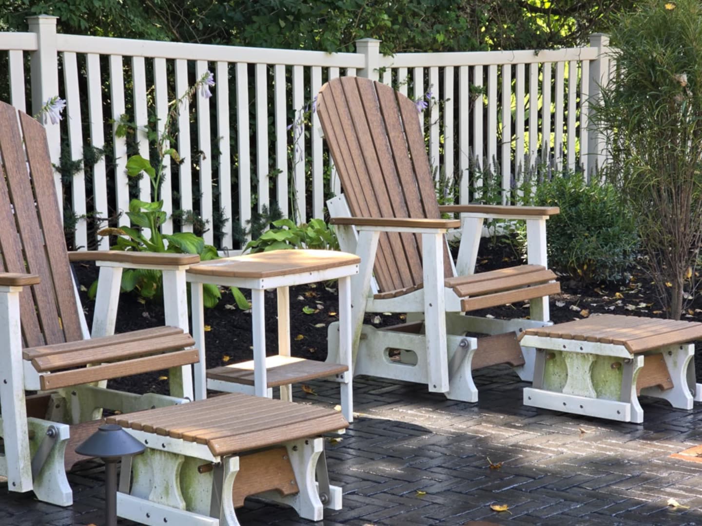 Adirondack chairs arranged on a private backyard patio