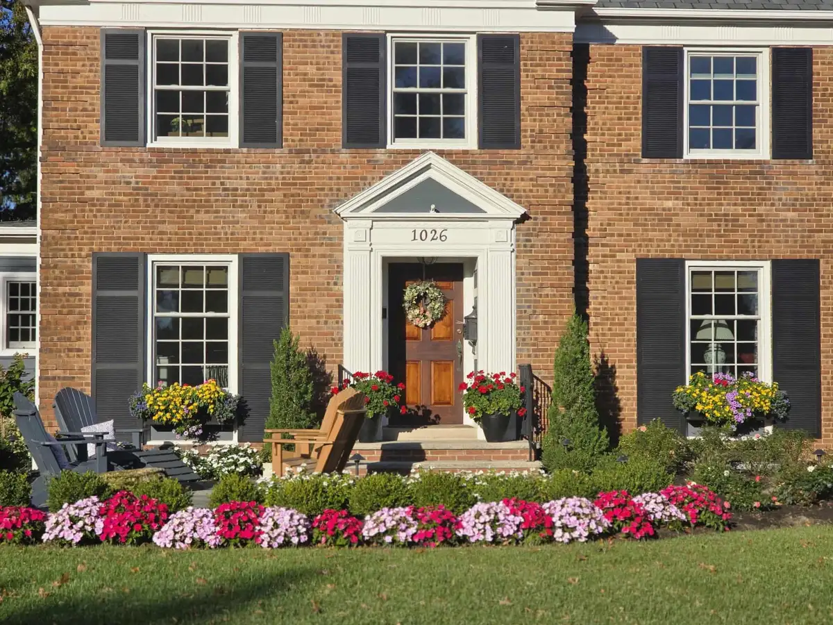 Paver patio with stone retaining walls and outdoor kitchen area