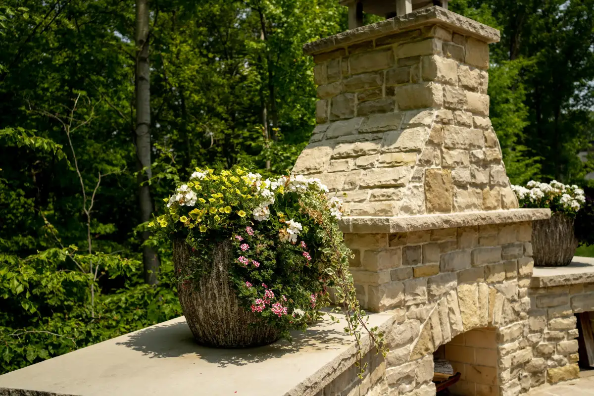 Landscape design detail with stone and seasonal planting by A.J. Kraig