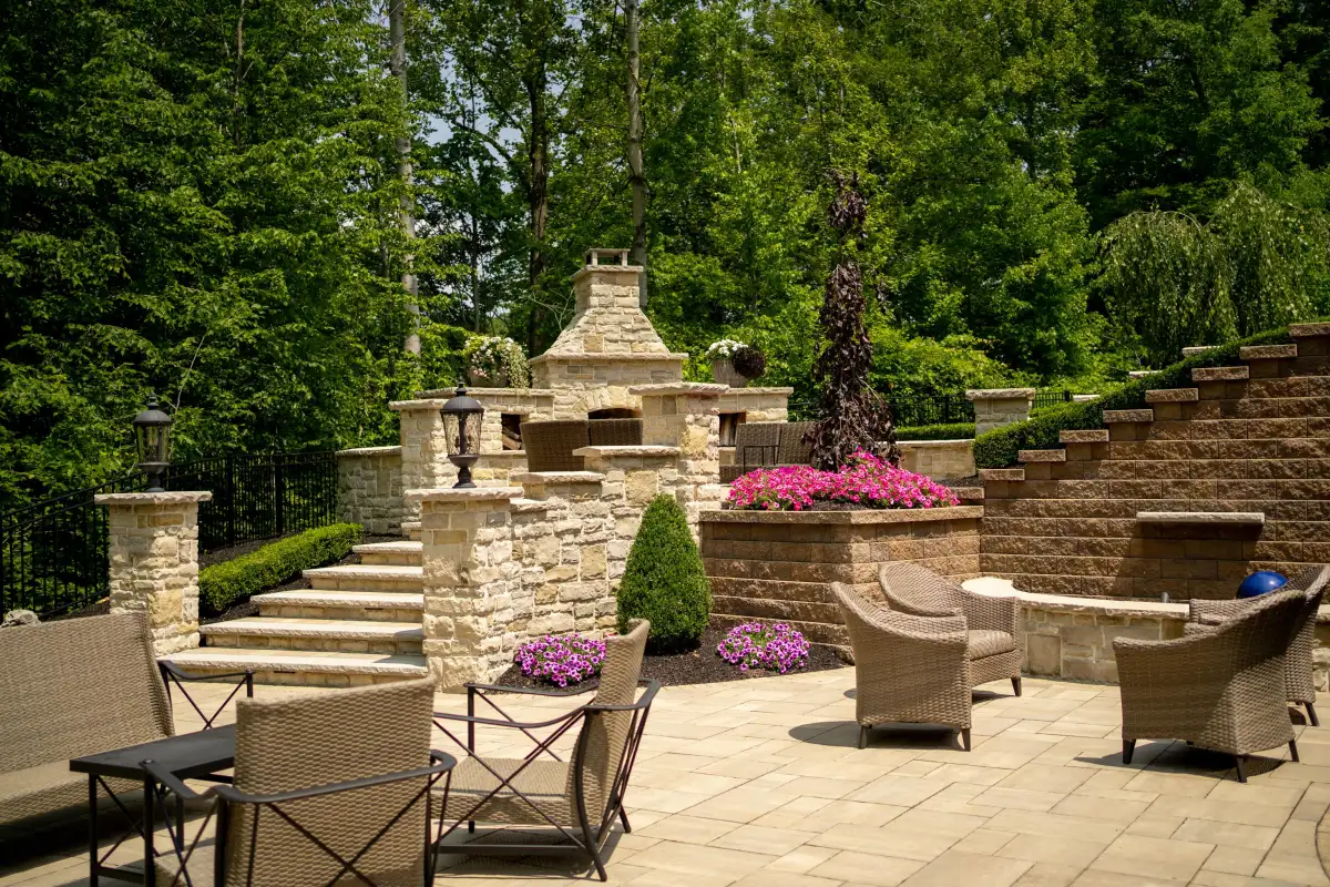 Multi-level stone patio and planting beds planned as one outdoor living space