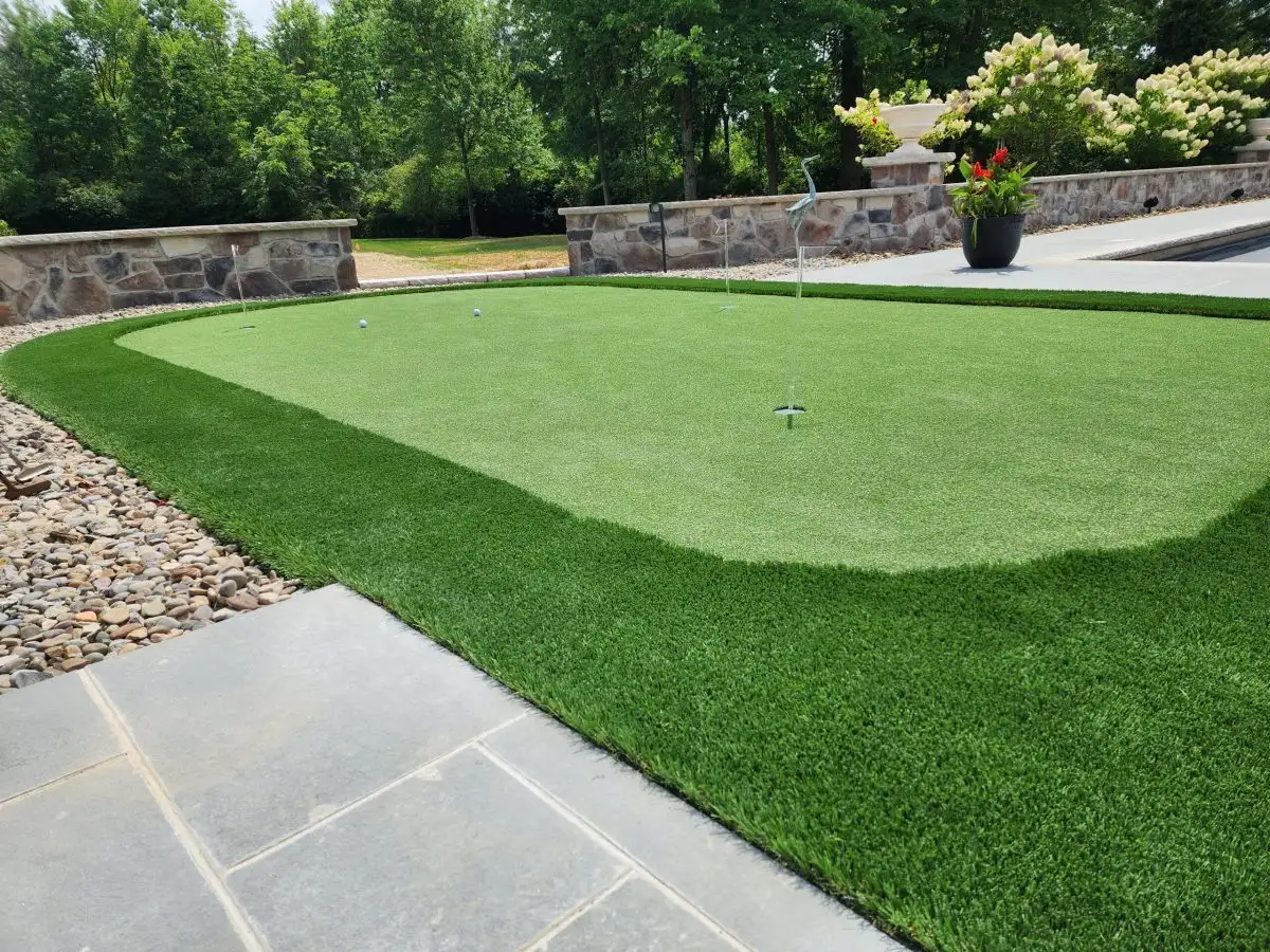 Putting green with stone border and landscaping